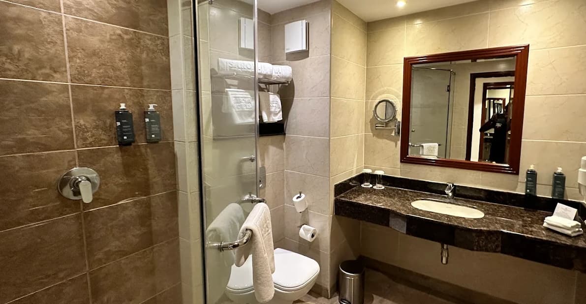 Luxurious ensuite bathroom at Sarova Woodlands Hotel & Spa Nakuru, one of the top lake nakuru lodges, featuring modern fixtures, elegant design, and premium amenities