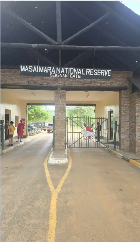 Nairobi to Masai Mara Drive 2026: Why the "6-Hour" Promise Costs Some Clients Their Entire First Game Drive 5 The Sekenani Gate entrance of the Masai Mara National Reserve showing the official signage and stone pillars.