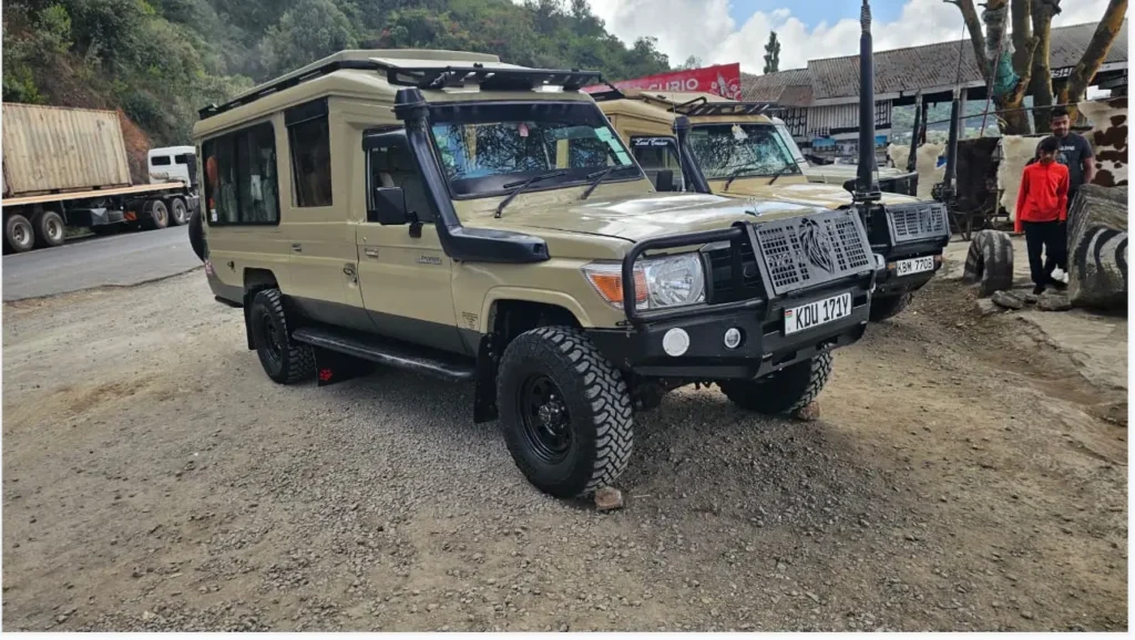 Nairobi to Masai Mara Drive 2026: Why the "6-Hour" Promise Costs Some Clients Their Entire First Game Drive 2 A tan Hilmuks safari Land Cruiser parked at the Milano Viewpoint on the Mai Mahiu escarpment road.