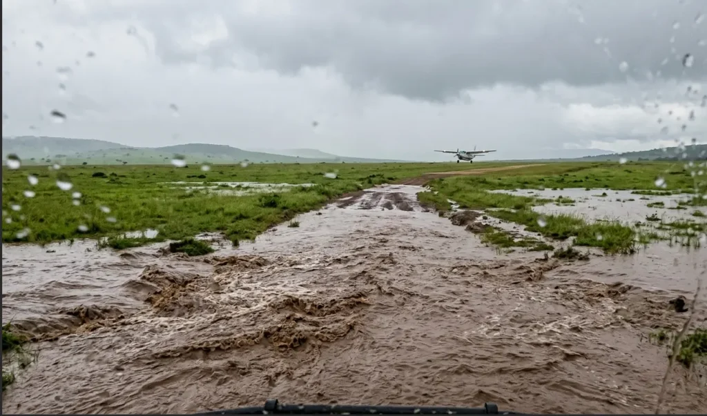 A flooded dirt road in the Masai Mara showing the risks of landing at the wrong airstrip.